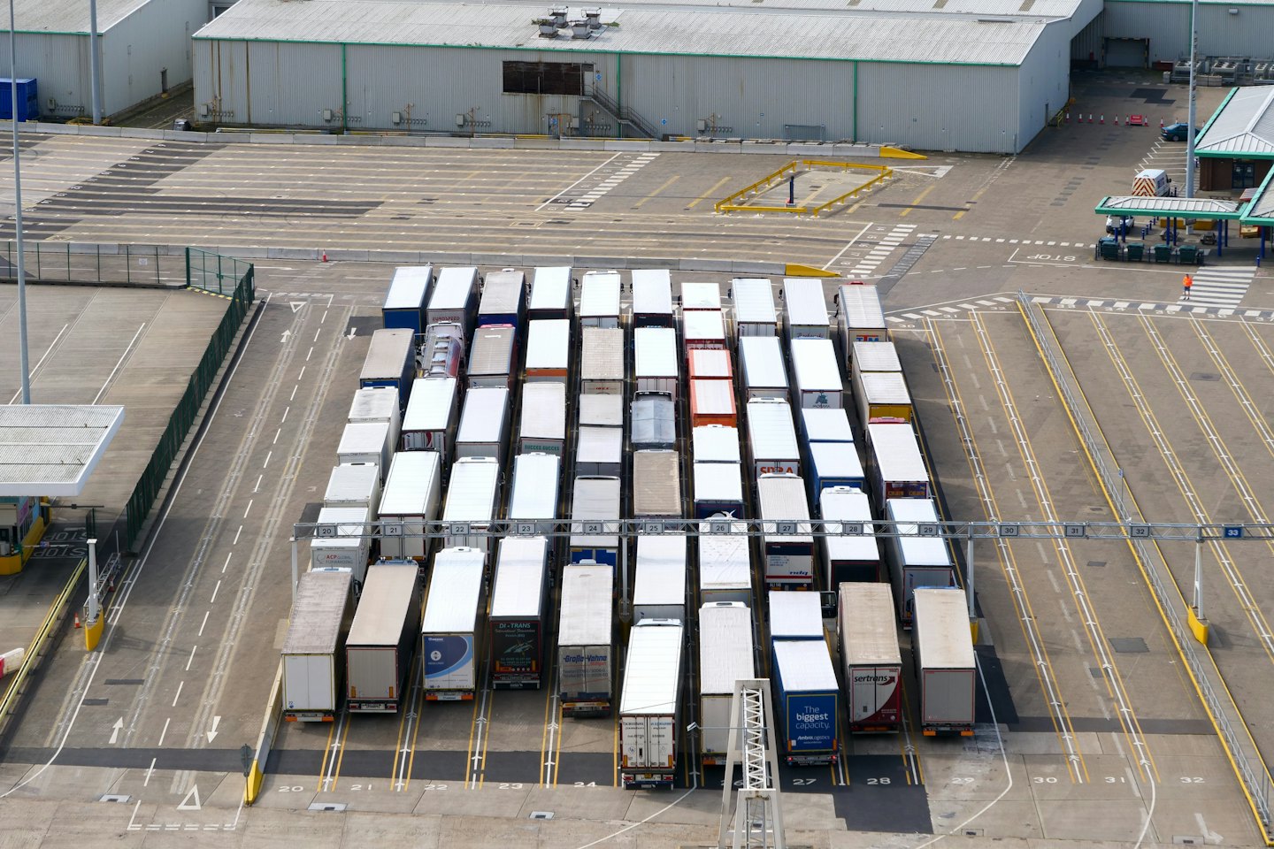 Semirimorchi parcheggiati in file in un terminal logistico.